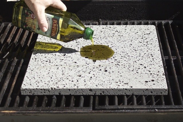Pouring Olive Oil on the Island Grillstone | Cooking-Outdoors.com | Gary House