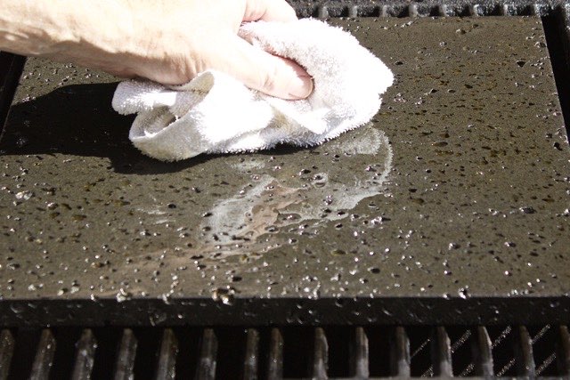 Wipe excess oil off the Island Grillstone | Cooking-Outdoors.com | Gary House