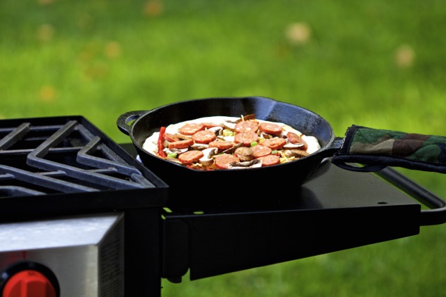 Linguica pizza ingredients loaded onto pizza dough| Cooking-Outdoors.com | Gary House