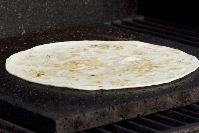 Warming a tortilla on the Island Grillstone| Cooking-Outdoors.com | Gary House