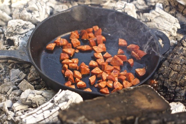 Saute the linguica in cast iron skillet | Cooking-Outdoors.com | Gary House